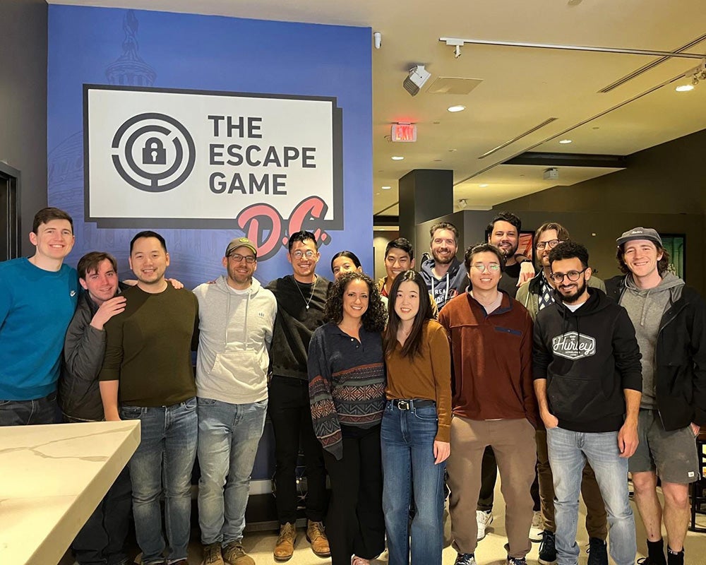 A group of residents stands together at the entrance to The Escape Game